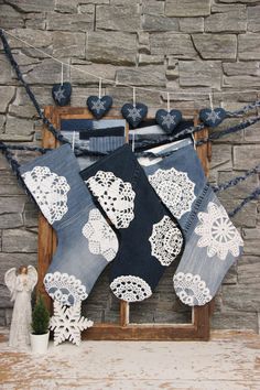 an old pair of jeans hanging on a clothes line with lace doily and hearts