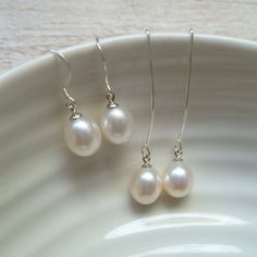 Pearl drop dangle earrings serve as a dainty and elegant accent without overpowering the rest of your outfit making them ideal as part of a bridal outfit or for the bridesmaids at your wedding.  The moment you choose to wear dainty pearl drop earrings, either basic or statement-like, it's best to tie up your hair in a bun or a more sophisticated updo to let the earrings stand out and enhance your facial features.  FEATURES: * real cultured freshwater pearls * ivory white with beautiful lustre * .925 sterling silver ear hooks  * nickel-free * entirely handmade in the UK * free first class shipping within UK  You may also like these pearl stud earrings here: https://www.etsy.com/listing/769109465/ Elegant White Drop Threader Earrings, White Drop Earrings For Bridesmaid Gift, Elegant Dangle Threader Earrings For Weddings, Classic Teardrop Earrings For Wedding, Silver Wedding Threader Earrings, White Sterling Silver Earrings For Bridesmaid Gift, Classic Wedding Teardrop Earrings, Classic White Long Drop Bridal Earrings, Elegant Teardrop Threader Earrings For Wedding