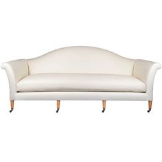 a white couch sitting on top of a wooden frame