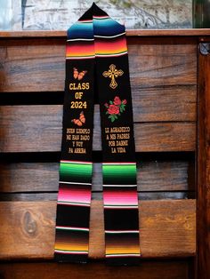 a pair of colorful skis hanging on a wooden bench