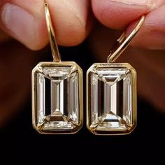 Dangle Drop Earrings Gift, 12x8MM Emerald Brilliant Cut Moissanite Wedding Earrings, Bezel Set In 14k Yellow Gold Latch Back Bridal Earrings ✹✹𝐖𝐞𝐥𝐜𝐨𝐦𝐞 𝐭𝐨 𝐂𝐫𝐚𝐳𝐲𝐃𝐢𝐚𝐦𝐨𝐧𝐝𝐬𝐂𝐨✹✹ Detail about stones Moissanite & Simulated Stone: ----------------------------- Stone Shape: Emerald Cut Stone Size: 12x8 mm Weight: 10.68 TCW Color: Colorless Cut: Excellent Clarity: VVS ★ 𝑰𝒕𝒆𝒎 𝑫𝒆𝒕𝒂𝒊𝒍𝒔:- ☛ Metal Purity: Solid Gold (10KT, 14KT, 18KT); Silver(925 Sterling, 935 Argentium), 950 Emerald Cut Earrings, Emerald Drop Earrings, Earring Bridal, Emerald Earrings Drop, Bezel Set Earrings, Bridal Earring, Bezel Earrings, Earrings Emerald, Emerald Cut Moissanite