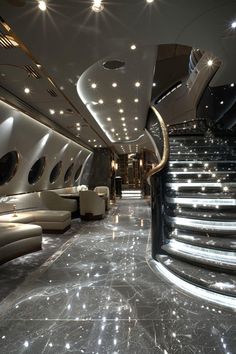 the interior of an airplane is lit up with lights and spiral staircases, as well as white couches