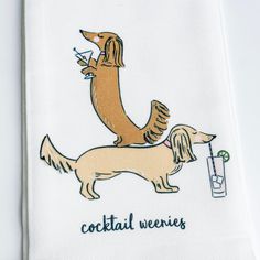 a white towel with a dog on it's side and the words cocktail wieners