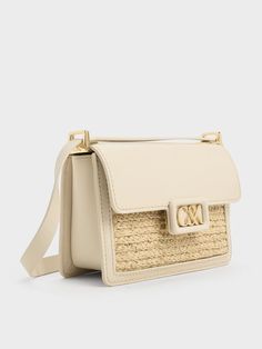 Travel light this summer with this leather and raffia boxy bag. This cute yet polished carrier juxtaposes a rustic woven texture against smooth calf leather -- it will stand out wherever you go. Made compact for convenience, it will hold all your essentials with ease. In neutral-toned beige, it is versatile enough to complement most outfits. Adjust the shoulder strap to your preference, or remove it entirely to transform this chic bag into a clutch. Boxy Bags, Brand Collaboration, Chic Bags, Woven Texture, Charles Keith, Travel Light, Trending Shoes, Leather Shoulder Bag, This Summer