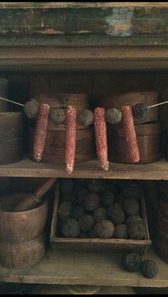 there are many pots and pans on the shelves in this room, one is filled with nuts