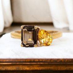 two yellow and brown rings sitting on top of a white cloth