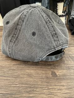 This Charcoal Denim Cap is the perfect addition to any wardrobe. With an adjustable back, it offers a comfortable fit for any size. The durable denim material ensures lasting quality, making it a great hat for everyday use. Denim Cap For Streetwear, Trendy Washed Snapback Hat, Denim Streetwear Cap, Casual Fitted Hat With Short Brim For Outdoor, Everyday Denim Hat With Short Brim, Adjustable Distressed Gray Hat, Adjustable Gray Distressed Hat, Adjustable Denim Cap, Casual Denim Trucker Hat