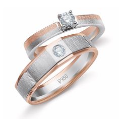 two wedding rings with diamonds on each side and one diamond in the middle, set against a white background