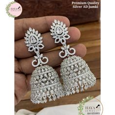 These stunning jhumka earrings are the perfect addition to any bride or bridesmaid's jewelry collection. They are made with high-quality materials and feature a beautiful kundan, beads, and cubic zirconia stones design. The earrings come in three colors: silver, white, and green and purple. The jhumkas are perfect for any wedding or engagement occasion. They are also a great gift for any woman who loves jewelry. Features: Made with high-quality materials Beautiful kundan, beads, and cubic zirconia stones design Available in three colors: silver, white, and green and purple Perfect for any wedding or engagement occasion Great gift for any woman who loves jewelry Materials: Kundan Beads Cubic zirconia stones Silver Care Instructions: To keep your jhumkas looking their best, simply wipe them Jewelry Materials, Jhumka Earrings, Cubic Zirconia Earrings, Wedding Jewelry Earrings, Cz Earrings, Zirconia Earrings, American Diamond, Stone Design, Bridesmaid Jewelry