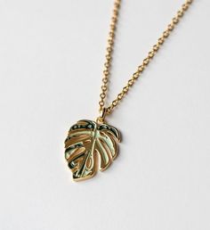 Perfect gift for the plant mom and nature enthusiast! This necklace is crafted in 18k gold plated over sterling silver. | Inspired by my very own Monstera deliciosa Albo, this gorgeous Monstera Deliciosa leaf necklace is plated in 18K Gold and has a Mirror- like finish. A perfect stunning necklace gift for nature enthusiast. | 1-800-Flowers Gifts Delivery Variegated Monstera Thai Constellation Necklace 18K Gold Gold Plated Leaf-shaped Jewelry For Gifts, Botanical Leaf Shaped Gold Jewelry, Leaf-shaped Yellow Gold Necklace, Gold Leaf Botanical Jewelry, Leaf-shaped Yellow Gold Necklace For Gift, Leaf-shaped Yellow Gold Plated Jewelry, Gold Leaf-shaped Jewelry Gift, Botanical Style Gold Leaf Jewelry, Yellow Gold Plated Leaf-shaped Jewelry