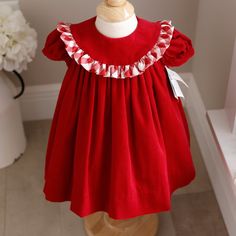 This Adorable Little Red Dress By Bailey Boys Is A Classic!!! The Dress In Done In A Gorgeous Deep Red And Is Made Of 100% Cotton, Pin Wale Corduroy- Super Soft And Cuddly! The Float Stlye Dress Has An Oversized Collat That Is Trimmed In A Beautiful Red And White Buffalo Plaid Ruffle. The Short Puff Sleeves Have A 1/2" Matching Corduroy Band For A Tailored Look. The Front And Back Top Have A Yoke, The Back Having A 2 Button Closure. The Dress Is Lined With A White Slip And Has A Small Tier Of Tu Christmas Cotton Dress With Ruffles, Cute Christmas Playtime Dress, Cute Christmas Playtime Dresses, Cute Red Holiday Dress, Cute Red Holiday Dresses, Cute Red Dress For Dress-up Occasions, Red Cotton Holiday Dress, Red Ruffled Dresses For Playtime, Cute Red Festive Dress