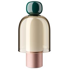 a white and gold bell with a green top sitting on a white surface next to a pink base