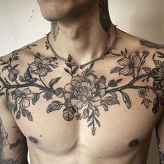 a shirtless man with tattoos on his chest