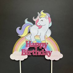 a cake topper that says happy birthday with a unicorn on it