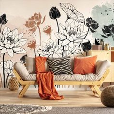 a living room with flowers painted on the wall and a couch in front of it