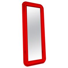 a red mirror sitting on top of a white wall