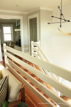 a living room with white walls and wood flooring