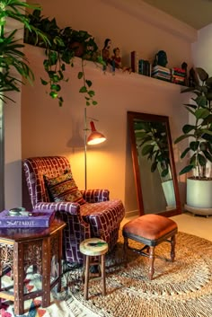 a living room filled with furniture and a plant on top of a wooden shelf next to a mirror