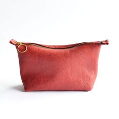 Introducing our Zipper Pouch – a versatile accessory perfect for countless uses! This design is the ideal blend of style and practicality for the minimalist who values both form and function. Crafted from premium full-grain leather, this piece is designed to be your go-to accessory for keeping your essentials close at hand. Plus, for added convenience, you can choose to include a wristlet strap as an additional add-on. Key Features: Elegant YKK Zipper pouch design Crafted from slouchy full grain Red Leather Enhanced with durable and stylish Brass Hardware Compact to fit nicely in our Totes + Bucket Bags, yet spacious enough for your essentials Measuring approximately 11" wide across top, 9” wide across bottom, 6" high, 3" deep Artisanal craftsmanship in Bellingham, Washington Questions? Co Organizing Accessories, Bellingham Washington, Pouch Design, Bucket Bags, Zipper Pouches, Handbag Straps, Ykk Zipper, Stitching Leather, Accessory Organization