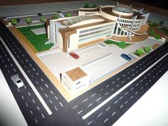 a model of a building with cars on the road