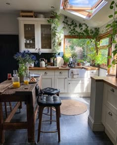 a kitchen filled with lots of counter top space next to a dining room table and chairs