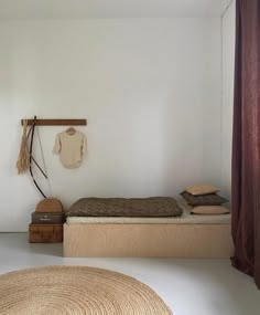 a room with a bed, rug and other items