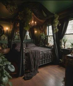 a bedroom with a canopy bed and lots of greenery