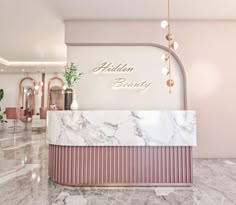 a marble reception counter in a pink and white lobby with gold lettering on the wall