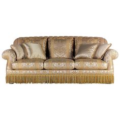 a couch with gold pillows and fringe trimmings on the arm, against a white background