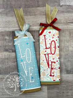 two wrapped candy bars with the word love on them