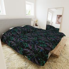 a bedroom with a bed and mirror on the wall next to carpeted flooring