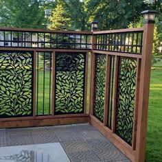 a wooden and metal fence in the middle of a park