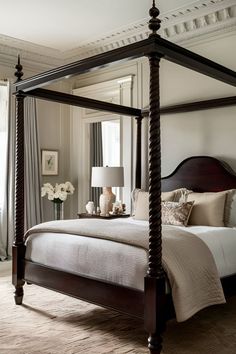 a bedroom with a four post bed in it