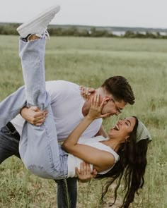 a man and woman are holding each other in the air