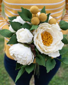 a woman holding a bouquet of flowers in her hands