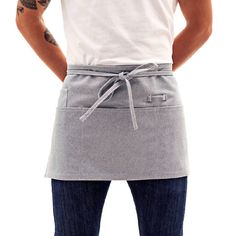 a man wearing an apron with his hands on his hips