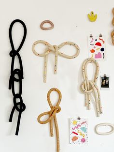 various craft items displayed on white surface including scissors, paper clips and rubber band rings