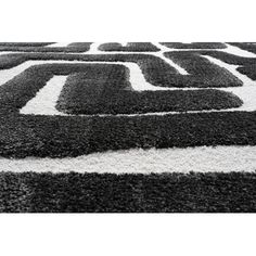 a black and white rug with an abstract design