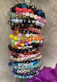 PRICED TO SELL: I'm selling off my remaining dance bracelet inventory to make room for next year's batch. Most are sized at 6.5 inches, but I can re-thread to fit your specified size. Additional discount for buying multiples; please send a message if you would like a quantity not shown in the option selections.  Friendship bracelets to show off your love for dance! A great gift idea for birthdays or recitals.  Bracelets are made with stretch cord, and beads vary between 6mm and 8mm. Custom sizin Beaded Rave Bracelets For Gifts, Adjustable Beaded Rave Bracelets, Adjustable Beaded Bracelets For Rave, Adjustable Round Beaded Bracelets For Rave, Personalized Multicolor Beaded Bracelets For Party, Adjustable Party Bracelets With Letter Beads, Adjustable Letter Beads Bracelets For Party, Party Stretch Bracelet With Letter Beads, Party Bracelets With Round Letter Beads