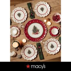 a christmas table setting with plates and candles