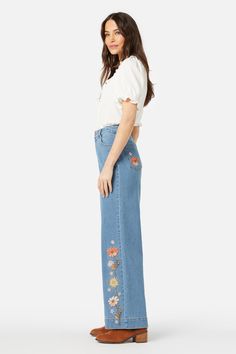 Denim embroidered jean featuring fresh cottage style floral celebrating spring. This cute jean has a high waisted fit, straight leg and slight stretch- floral embroidery along side of leg - high waisted rise - handy belt loops & pockets - straight cut full length leg - made of a cotton elastane blend denim - available in mid denim Product Code: PGFY055