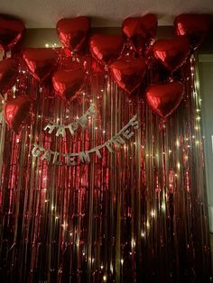 red balloons and streamers are hanging from the ceiling