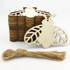 a stack of coins next to a wooden cutout of a bee