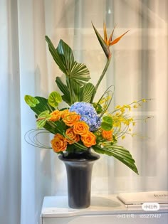 an arrangement of flowers in a black vase