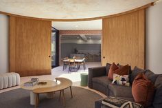 a living room filled with furniture next to a dining table and window covered in wooden slats