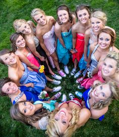 a group of women standing in the middle of a circle together on top of grass