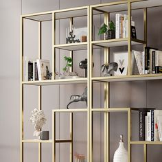 a gold shelf with books and vases on it