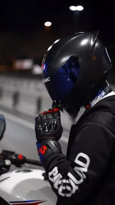 a person wearing a helmet and gloves on a motorcycle