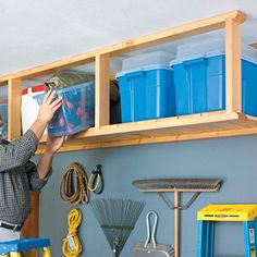 a man is working on some shelves in his garage