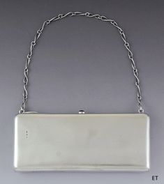 "Presented is a fantastic quality vintage Estonian silver clutch style handbag,    dating to circa 1924-1939. The clutch is rectangular with a very sleek and    smooth design. The \"strap\" is a silver chain, with twist design links. The    interior is lined in rich green velvet. The case opens with a little thumbpiece    set with a red stone. The overall look is incredibly stylish.      This piece is in excellent overall condition. There is some minor wear to the    lining, please view the phot Silver Clutch Purse, Silver Bag, Art Deco Silver, Silver Clutch, Silver Bags, Stylish Art, Rich Green, Pocket Book, Red Stone